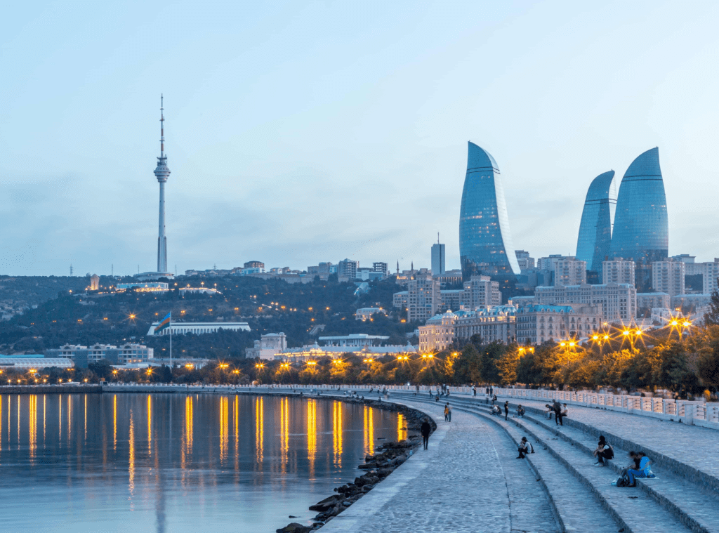 Families and tourists strolling along Baku's palm-lined Seaside Boulevard with the Caspian Sea stretching to the horizon on a sunny afternoon  to do in Baku Baku travel guide 2026